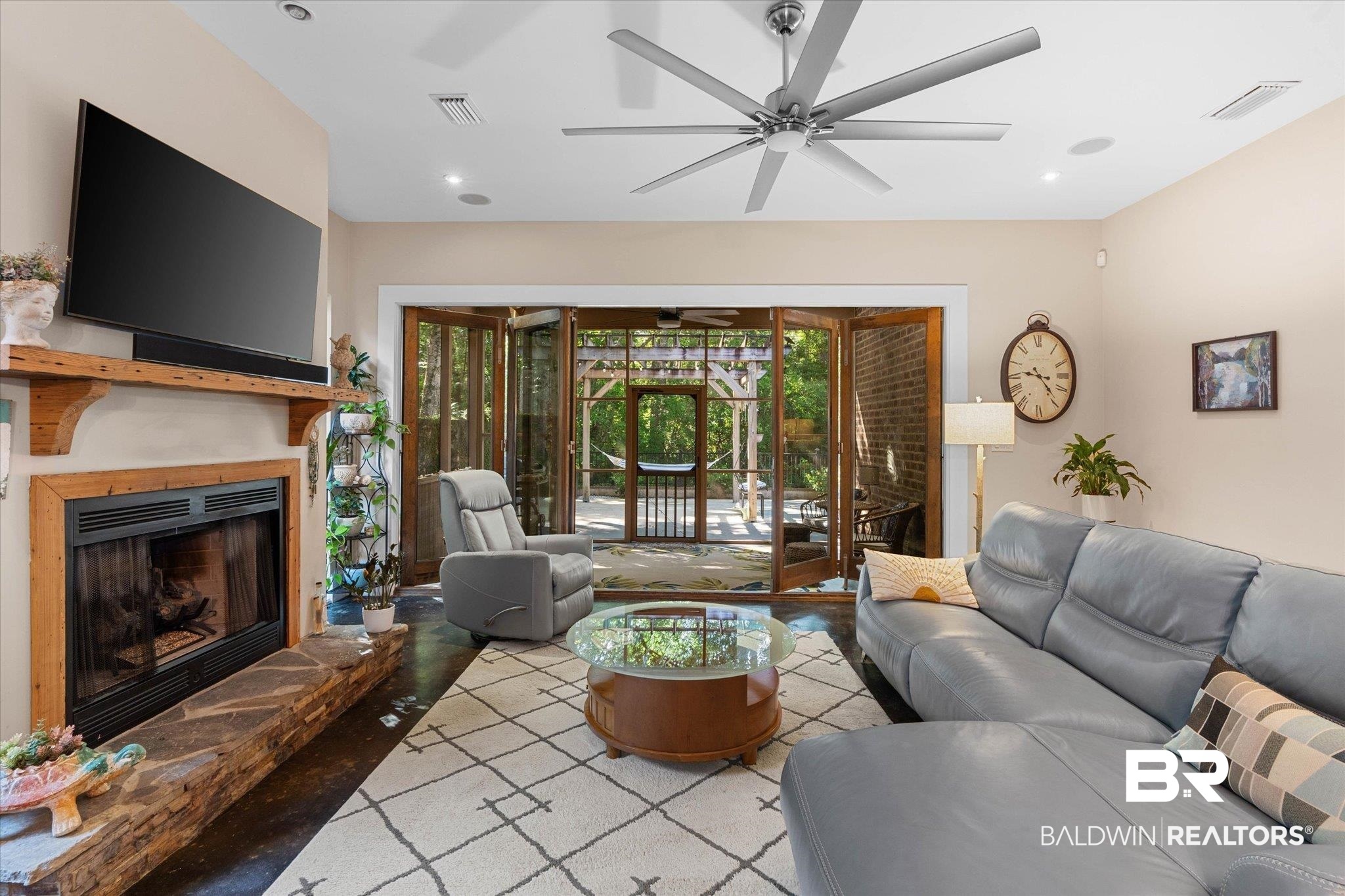 3400 Rue Royal Mobile, AL 36693 - Photo 5 of 33 Living room featuring a ceiling fan, a fireplace with raised hearth, recessed lighting, and wood finished floors