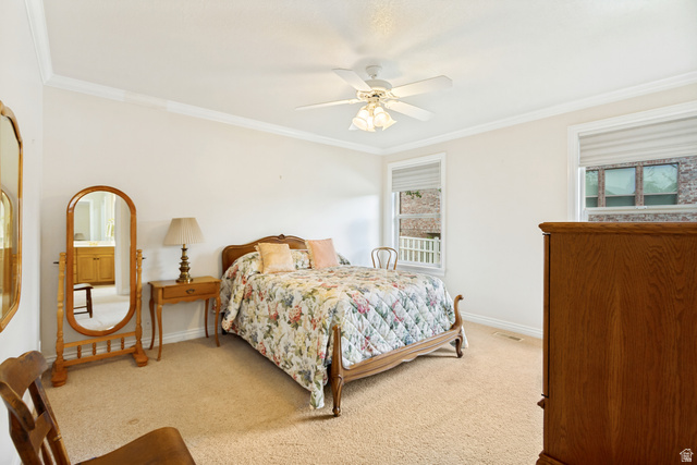 298 North Canyon Road Bountiful, UT 84010 - Photo 27 of 57 Carpeted room featuring crown molding, two windows with blinds, and a ceiling fan with light fixture