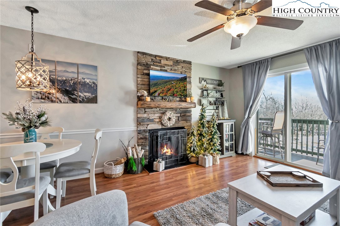a living room with furniture a fireplace and a chandelier