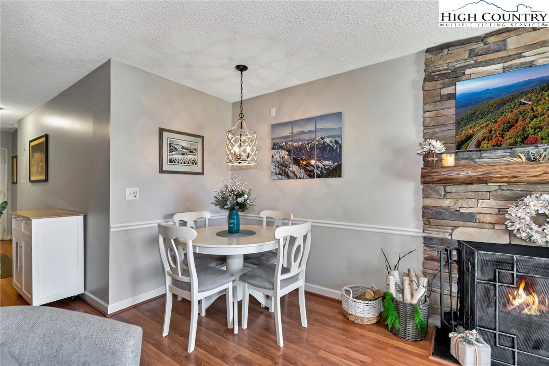 301 Pinnacle Inn Road, Unit 1215 Banner Elk, NC 28604 - Photo 14 of 47 a view of a dining room with furniture and wooden floor