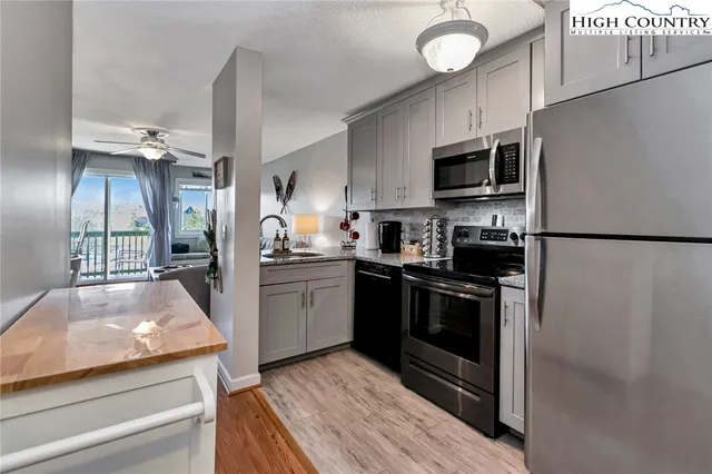 a kitchen with refrigerator a stove and cabinets
