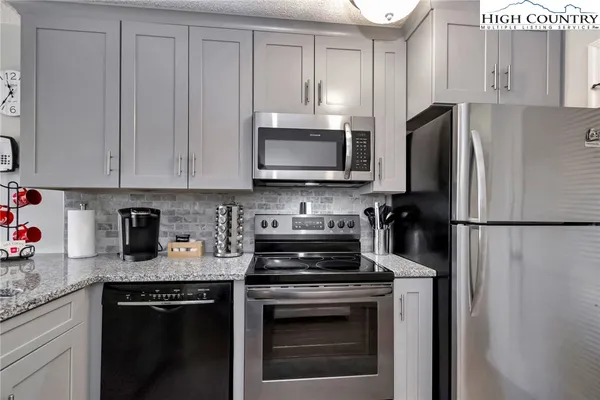 a kitchen with a refrigerator stove and microwave