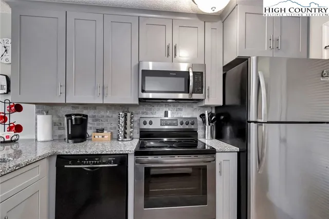 a kitchen with a refrigerator stove and microwave