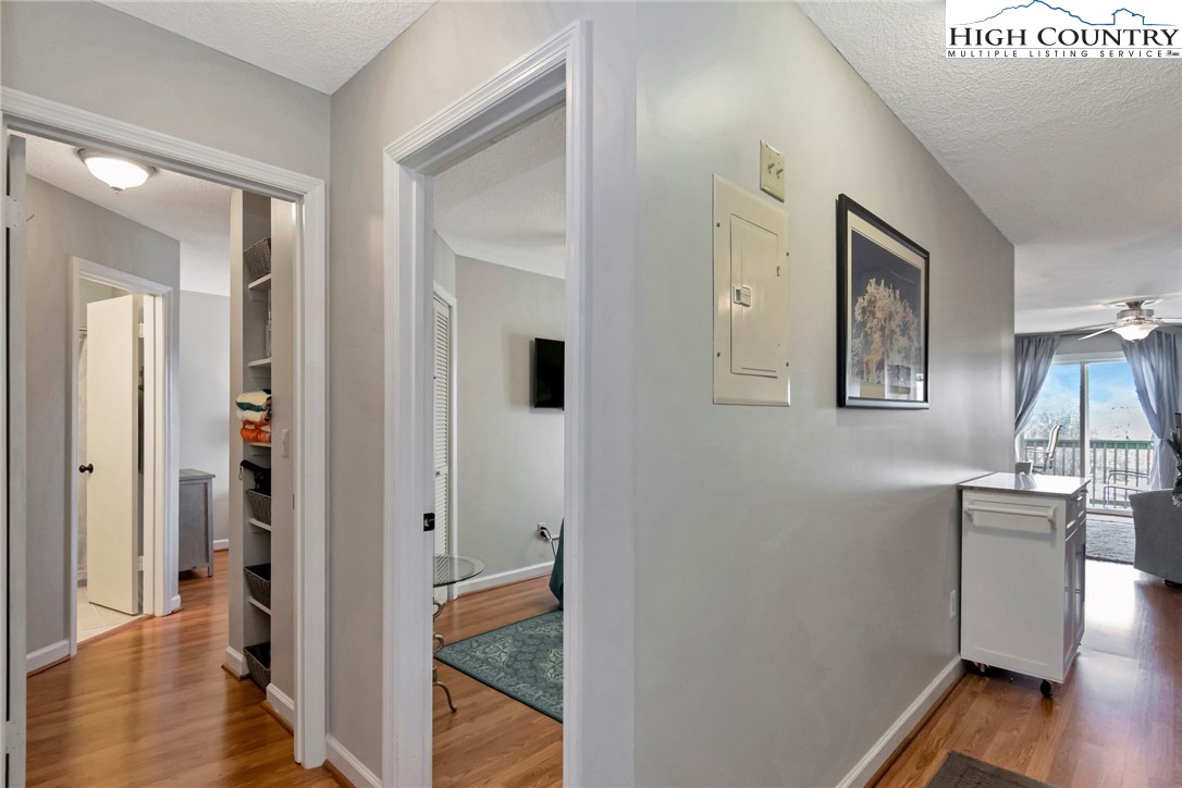 301 Pinnacle Inn Road, Unit 1215 Banner Elk, NC 28604 - Photo 21 of 47 a view of a hallway with wooden floor and a bathroom