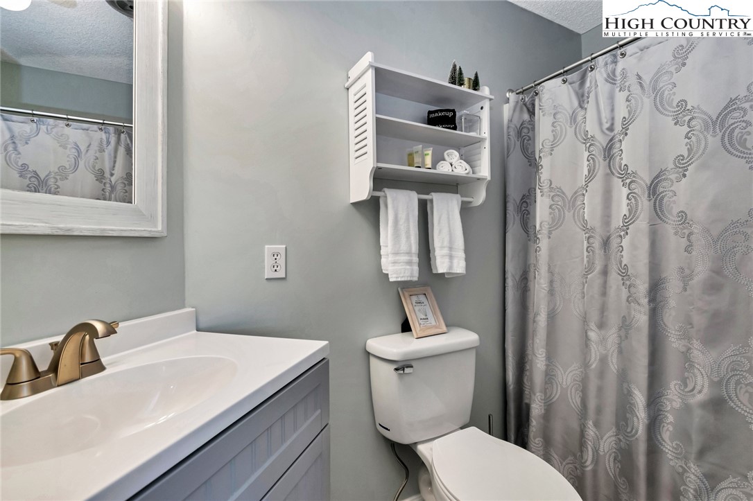 301 Pinnacle Inn Road, Unit 1215 Banner Elk, NC 28604 - Photo 25 of 47 a bathroom with a toilet sink and vanity