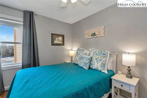 a spacious bedroom with a bed and a chandelier