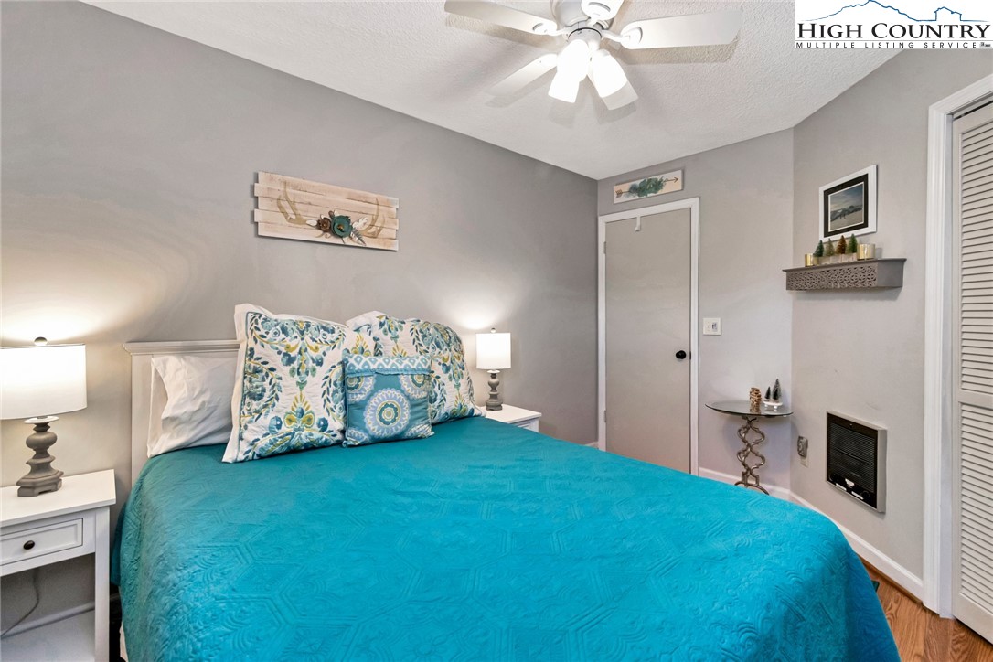 301 Pinnacle Inn Road, Unit 1215 Banner Elk, NC 28604 - Photo 29 of 47 a spacious bedroom with a bed and a chandelier