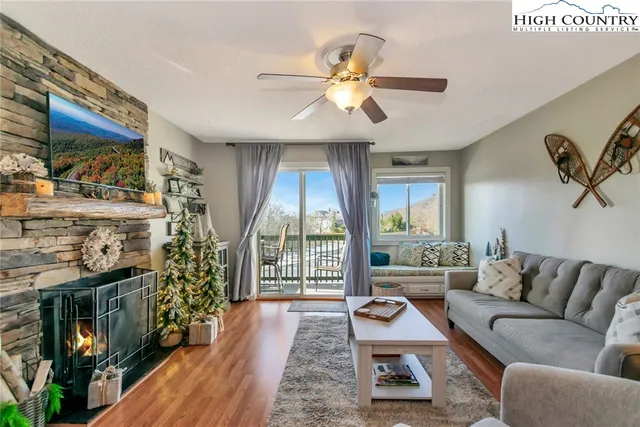 a living room with furniture and a floor to ceiling window