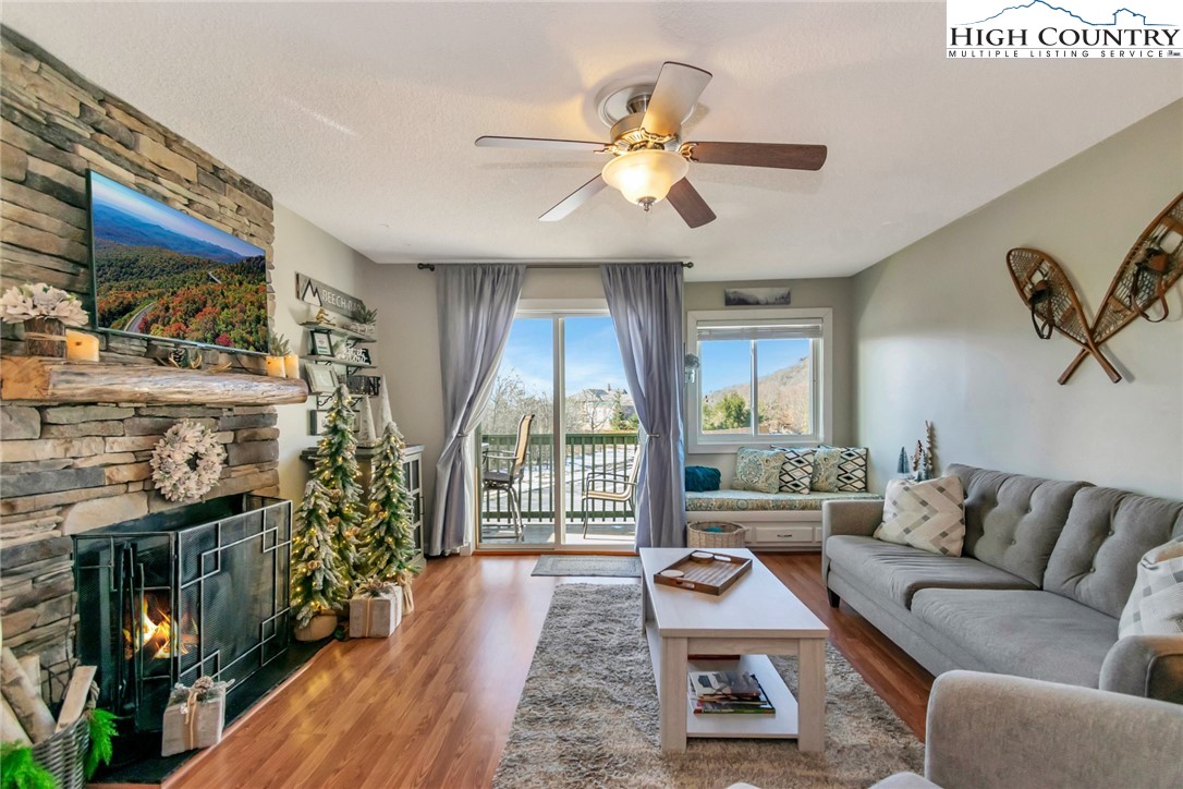 301 Pinnacle Inn Road, Unit 1215 Banner Elk, NC 28604 - Photo 6 of 47 a living room with furniture and a floor to ceiling window