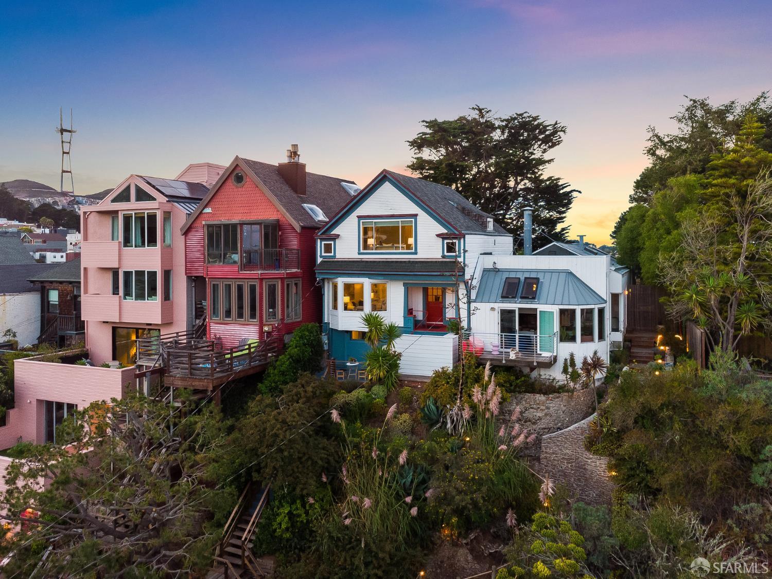 a front view of a houses with yard and green space