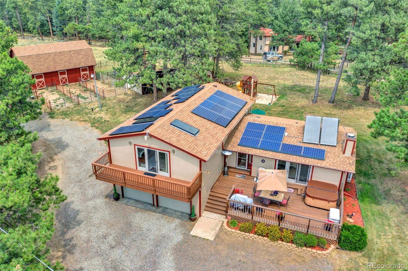 an aerial view of a house with swimming pool and sitting area