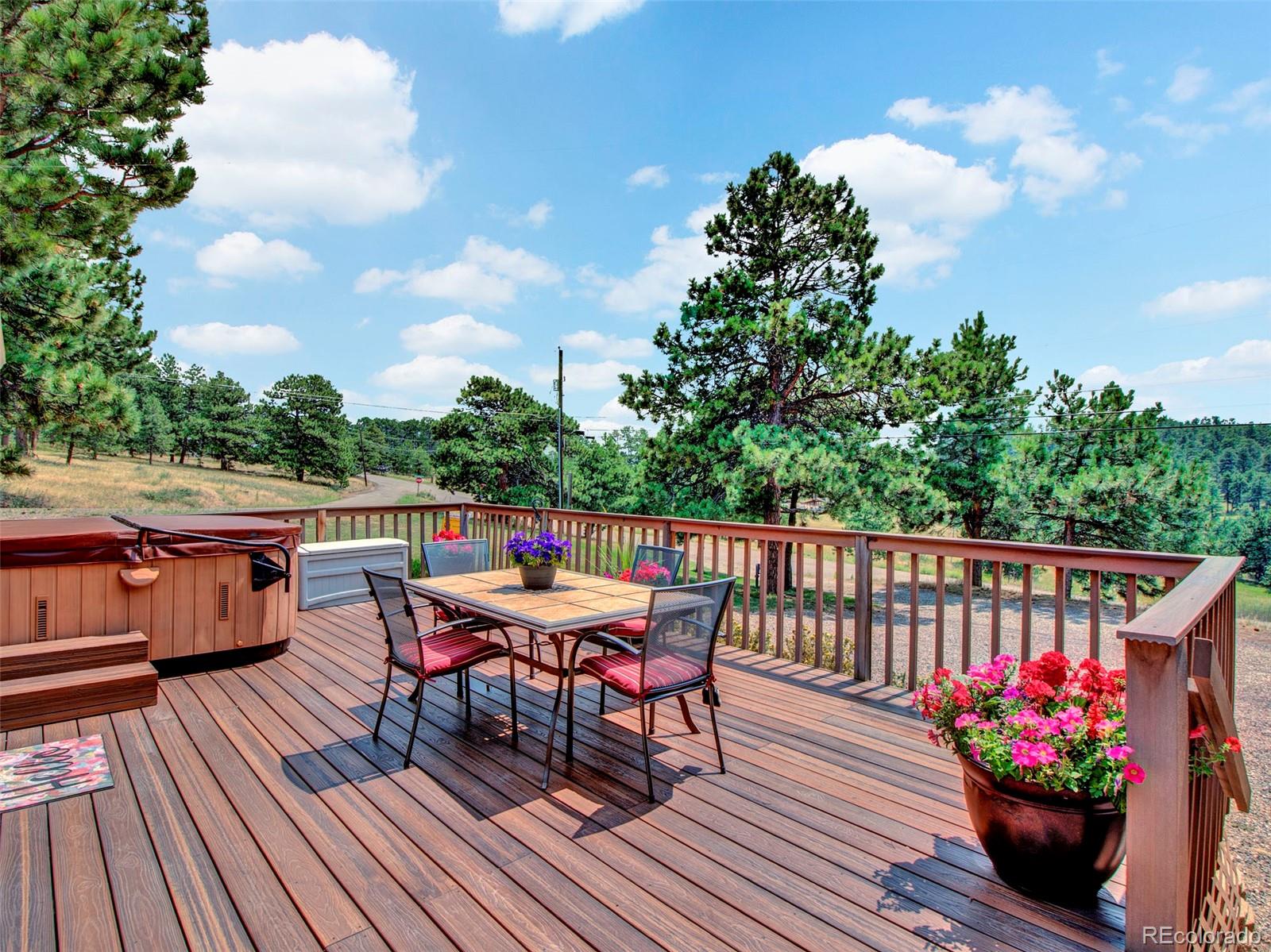 651 Lindsey Road Golden, CO 80401 - Photo 26 of 40 a balcony with wooden floor table and chairs