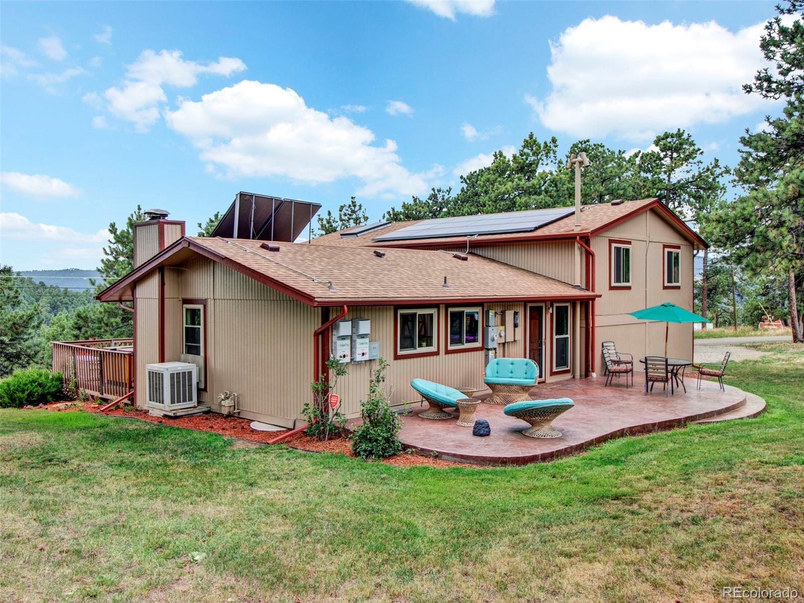 651 Lindsey Road Golden, CO 80401 - Photo 31 of 40 a view of a house with backyard sitting area and garden