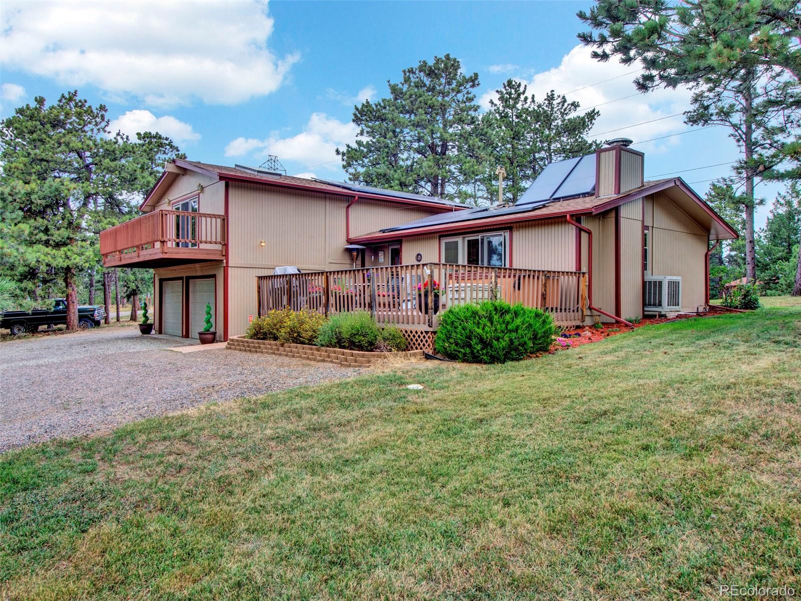 651 Lindsey Road Golden, CO 80401 - Photo 32 of 40 a view of a yard in front of a house with large tree