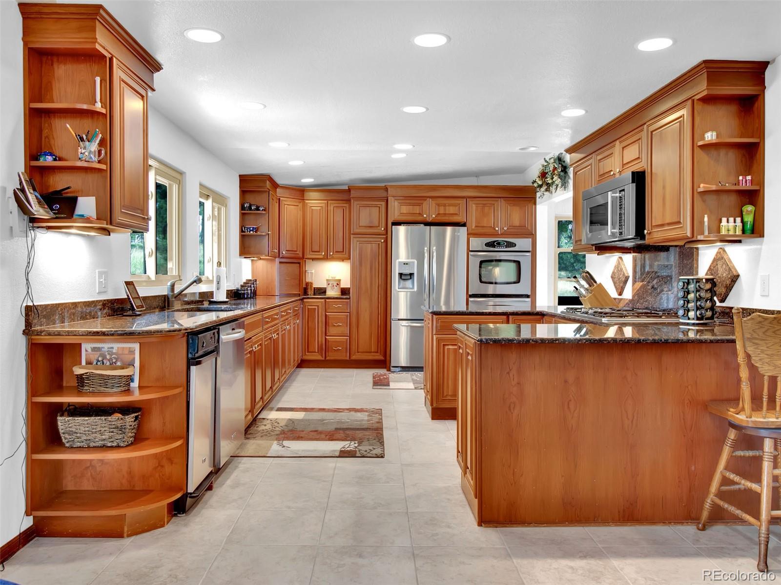 651 Lindsey Road Golden, CO 80401 - Photo 6 of 40 a kitchen with stainless steel appliances granite countertop a refrigerator and a stove