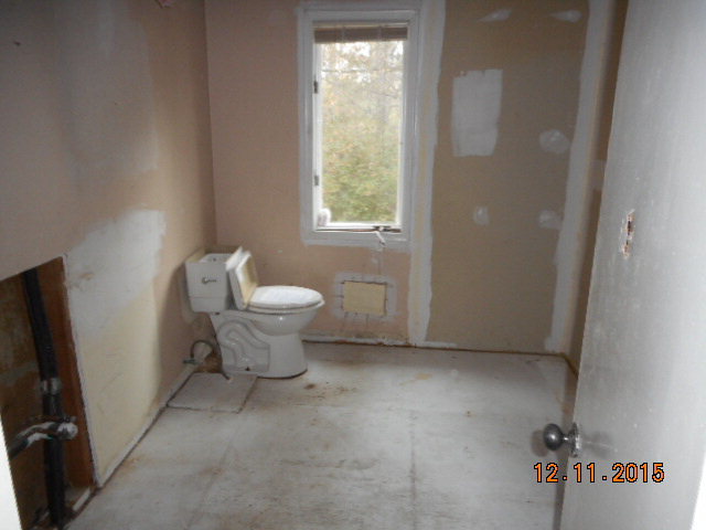 7331 Quail Run Road Lizella, GA 31052 - Photo 14 of 23 a bathroom with a toilet sink and window