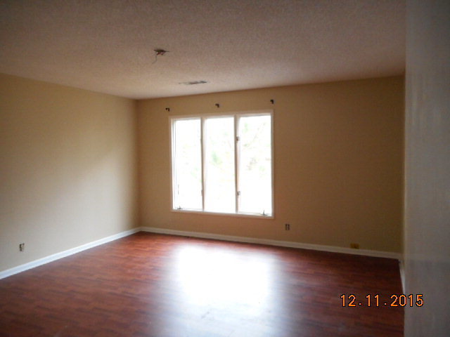 7331 Quail Run Road Lizella, GA 31052 - Photo 18 of 23 an empty room with wooden floor and windows