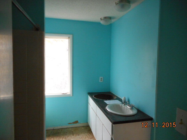 7331 Quail Run Road Lizella, GA 31052 - Photo 20 of 23 a bathroom with a granite countertop sink and a toilet