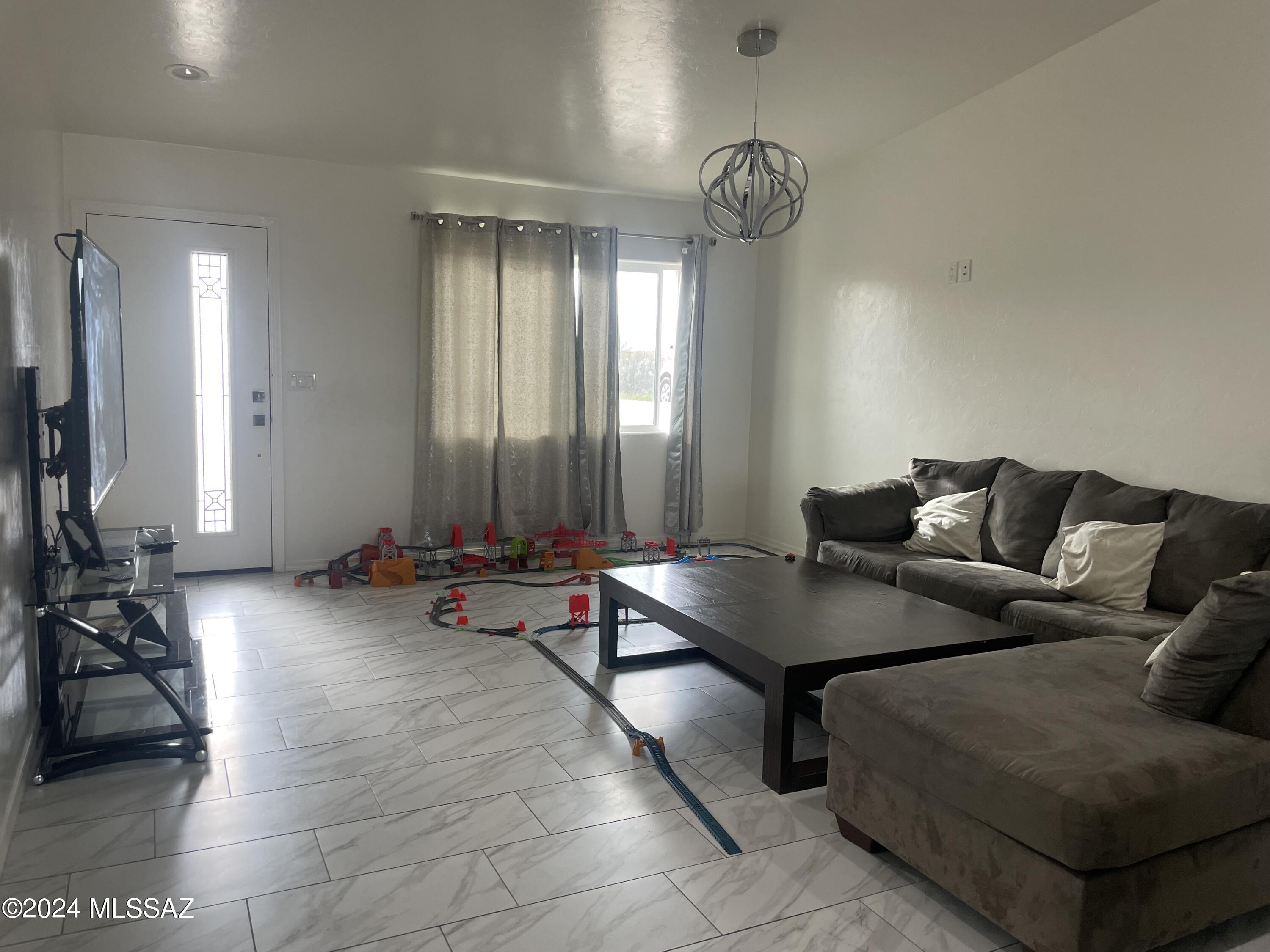 964 Calle Coyote Rio Rico, AZ 85648 - Photo 4 of 16 a living room with furniture and a large window