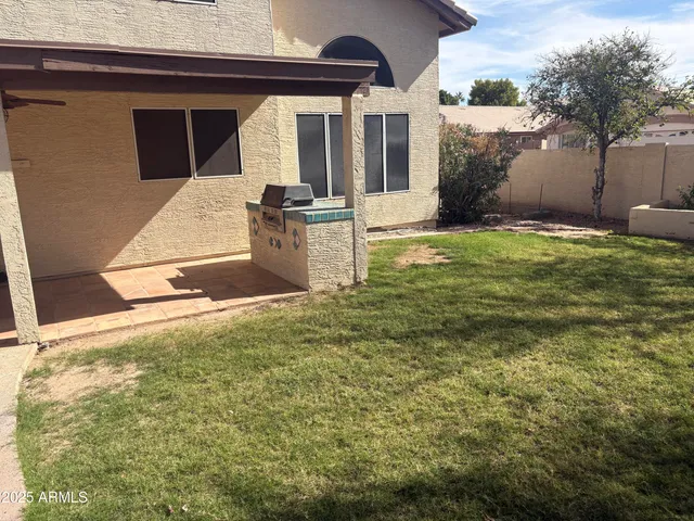 a view of a livingroom with wooden floor and a ceiling fan
