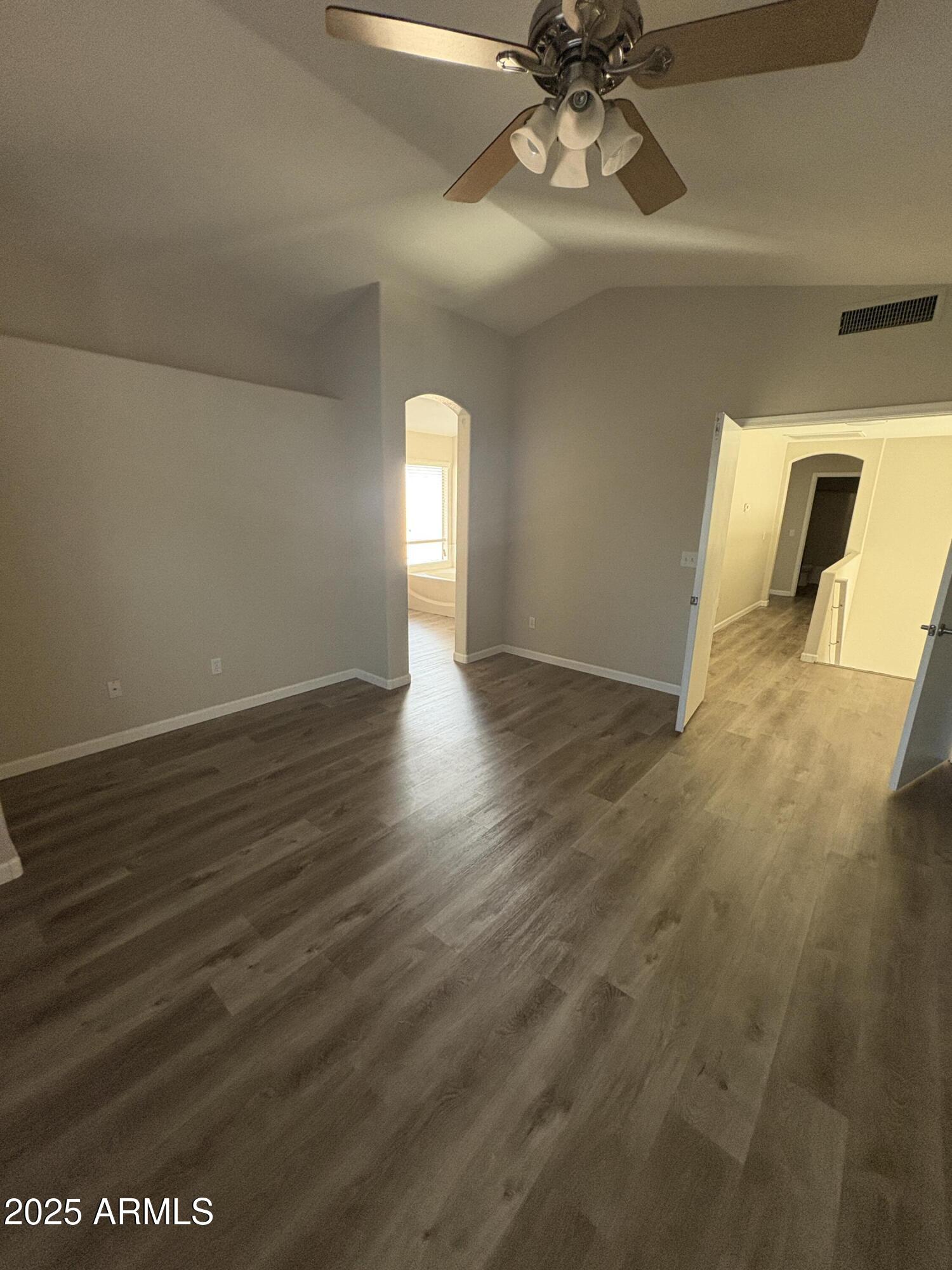 1472 East Constitution Drive Chandler, AZ 85225 - Photo 16 of 27 a view of a livingroom with wooden floor and a ceiling fan