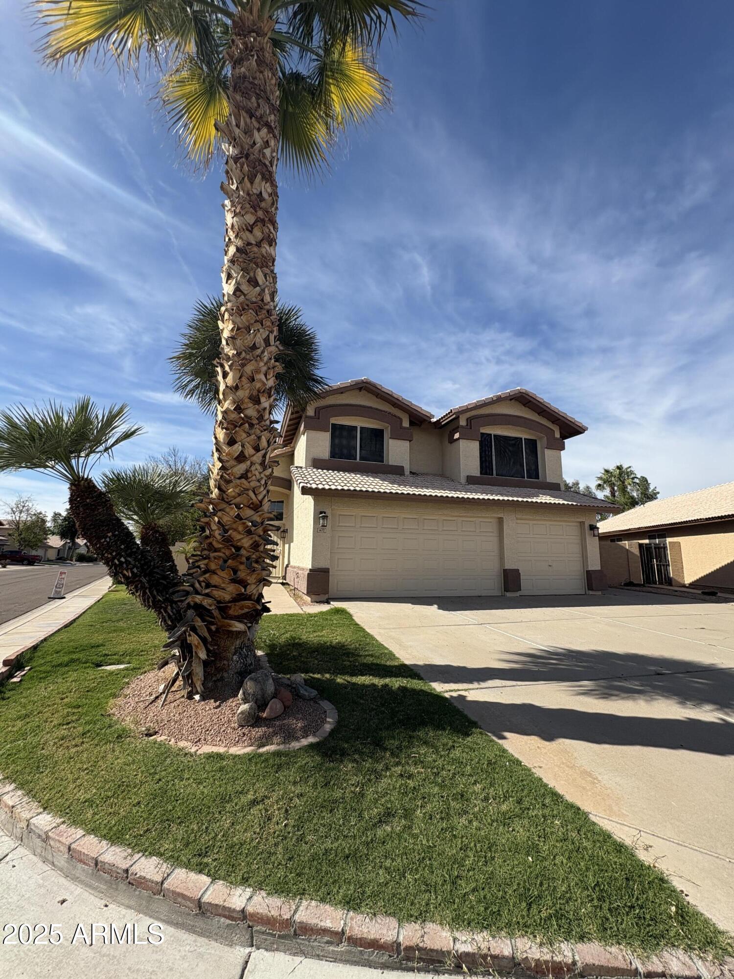 1472 East Constitution Drive Chandler, AZ 85225 - Photo 2 of 27 a front view of a house with a yard