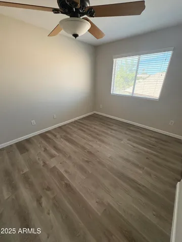 a view of an empty room with a fan