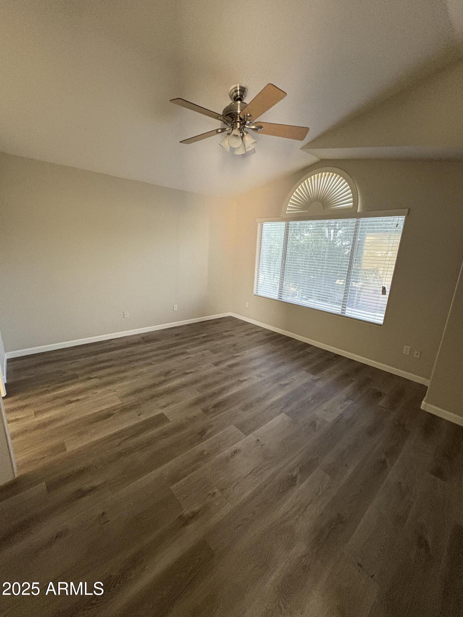 1472 East Constitution Drive Chandler, AZ 85225 - Photo 25 of 27 an empty room with wooden floor fan and windows