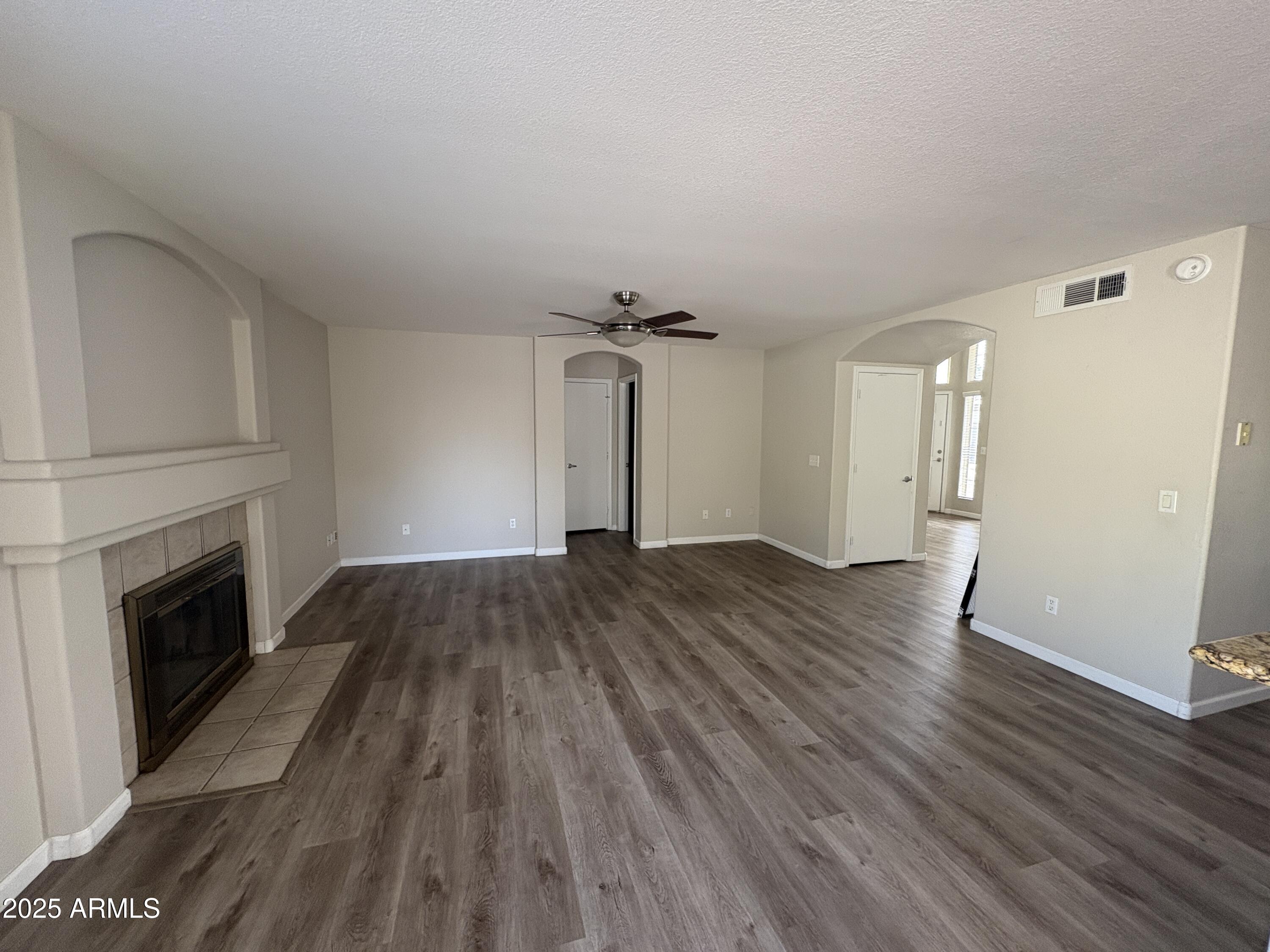 1472 East Constitution Drive Chandler, AZ 85225 - Photo 6 of 27 wooden floor in an empty room with a fireplace