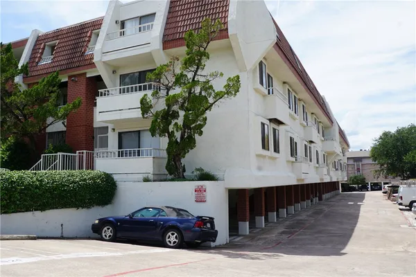 a view of a car park in front of house