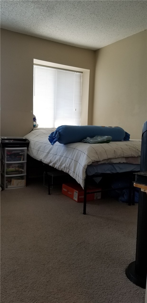 3115 Helms Street, Unit 212 Austin, TX 78705 - Photo 13 of 15 a bedroom with a bed and a window