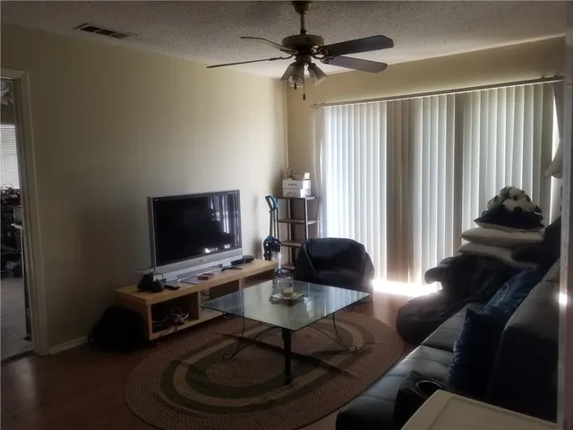 a kitchen with a table chairs refrigerator and microwave