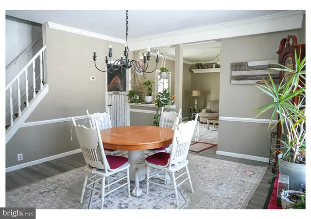 a view of a dining room with furniture and a potted plant