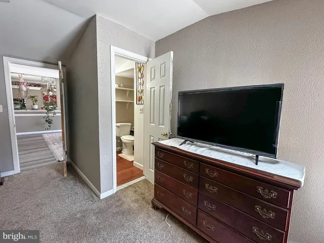 a living room with furniture and flat screen tv