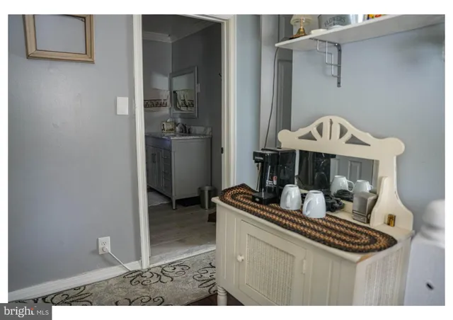 a kitchen view with a stove a refrigerator and a sink