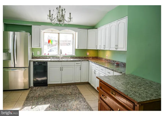 a kitchen with a sink stove and refrigerator