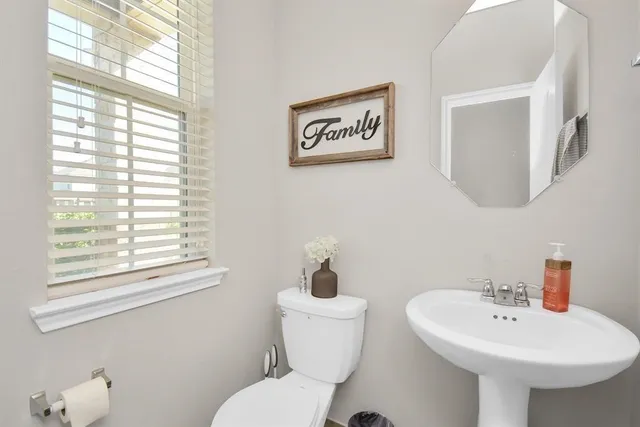 a bathroom with a toilet sink and mirror