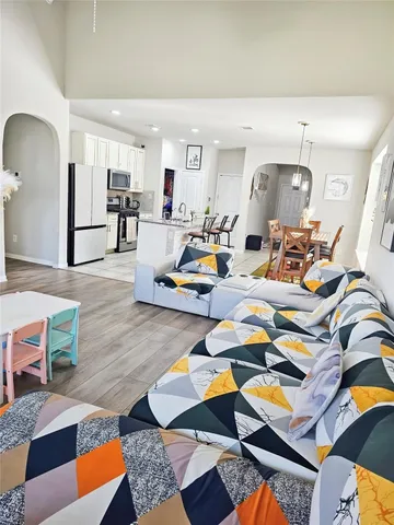 a living room filled with furniture and wooden floor