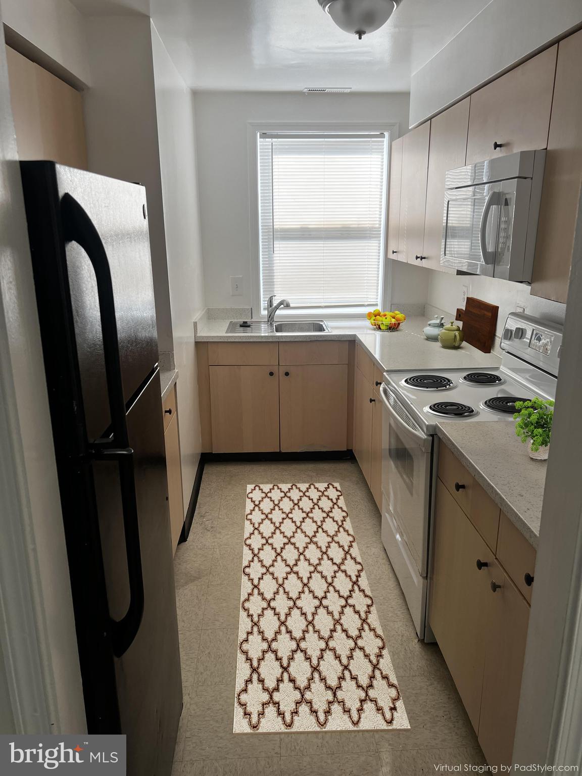 330 37th Street Southeast, Unit T2 Washington, DC 20019 - Photo 5 of 9 a kitchen with stainless steel appliances a refrigerator sink and stove