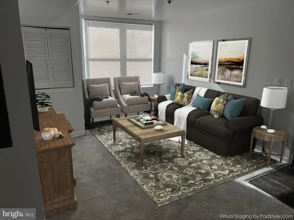 a living room with furniture wooden floor and a large window