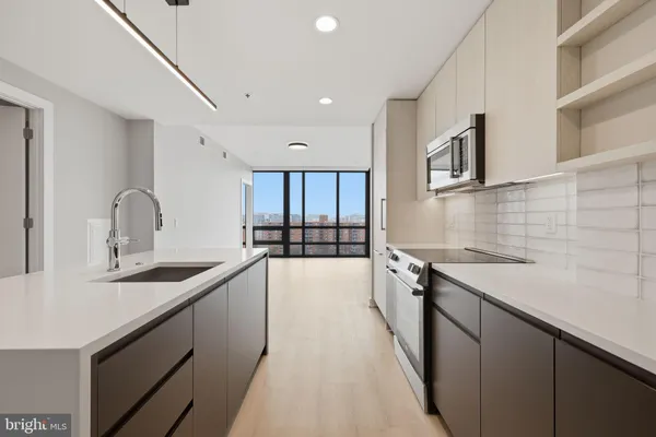 a view of a kitchen with a sink and a large window