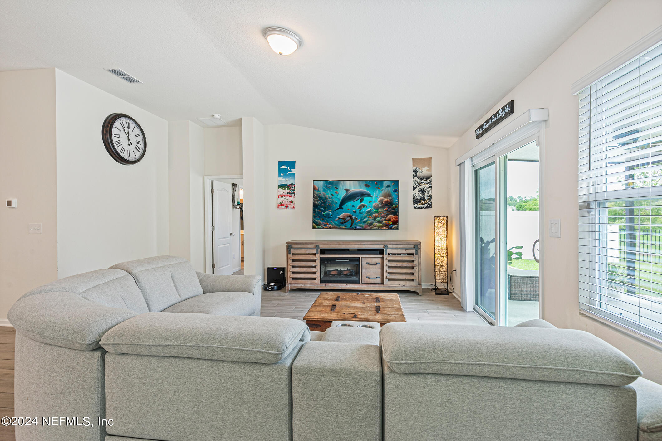340 Chasewood Drive St. Augustine, FL 32095 - Photo 15 of 46 a living room with furniture a flat screen tv and a window