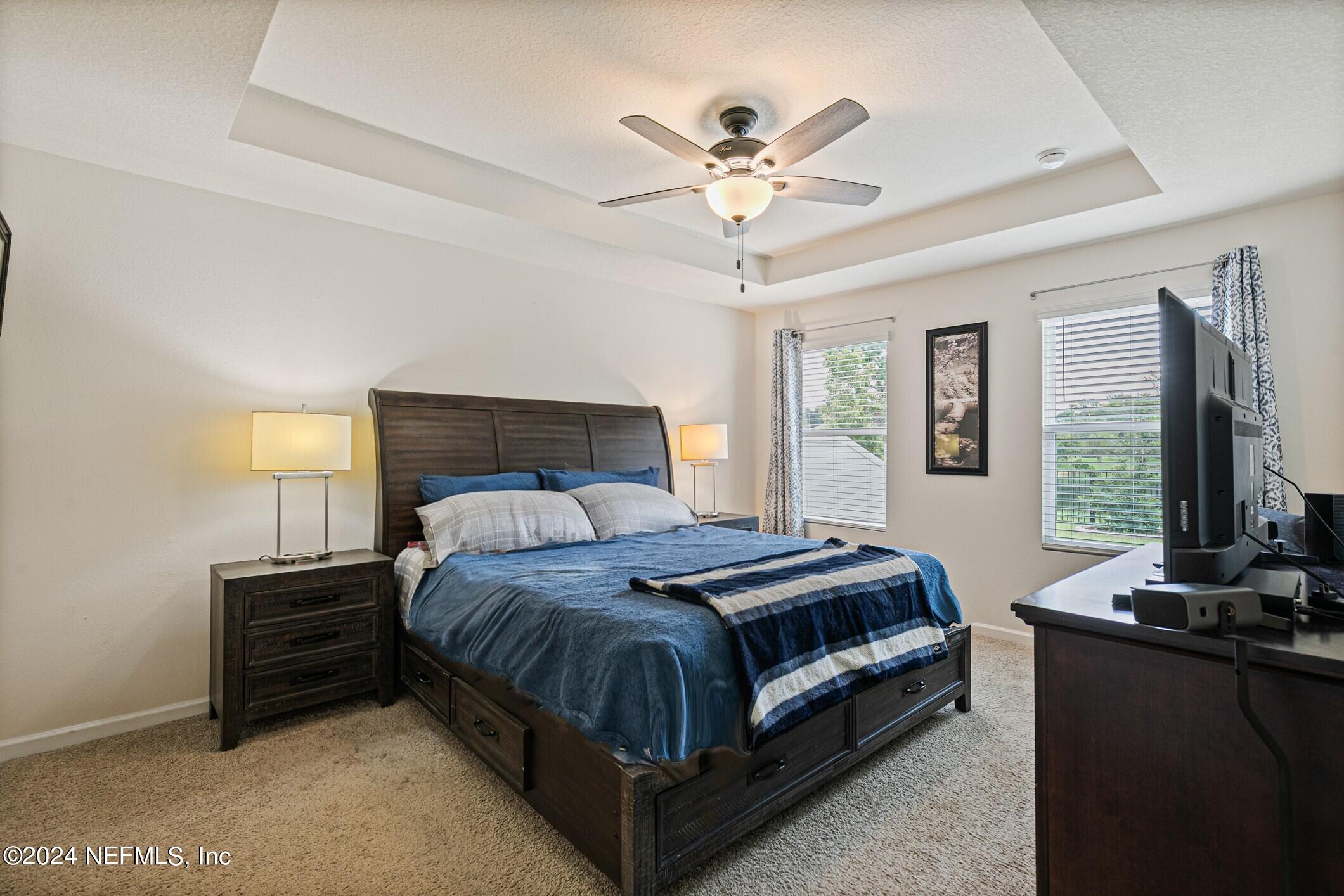 340 Chasewood Drive St. Augustine, FL 32095 - Photo 19 of 46 a bed room with a bed and a flat tv screen