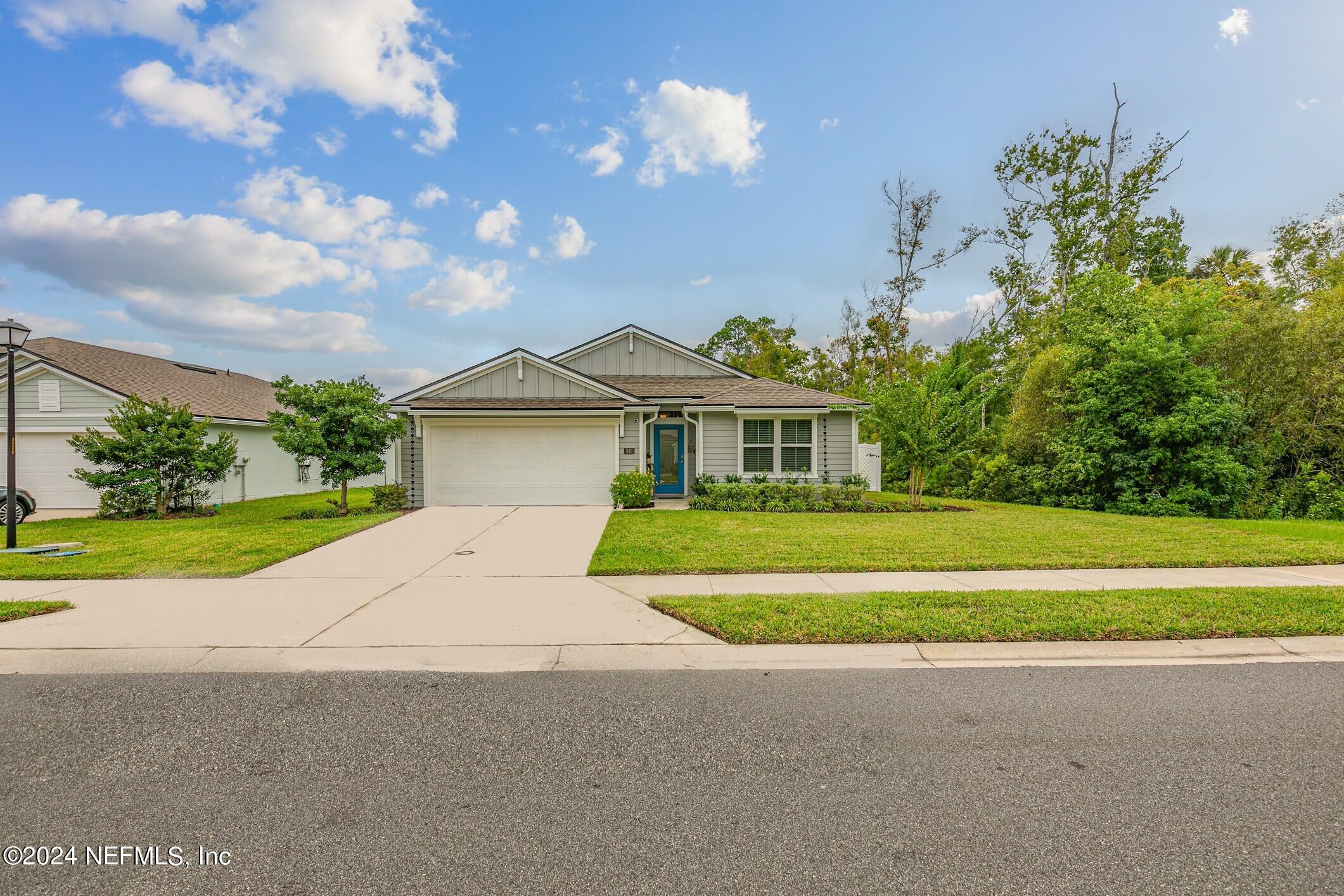 340 Chasewood Drive St. Augustine, FL 32095 - Photo 2 of 46 a front view of a house with a yard and garage