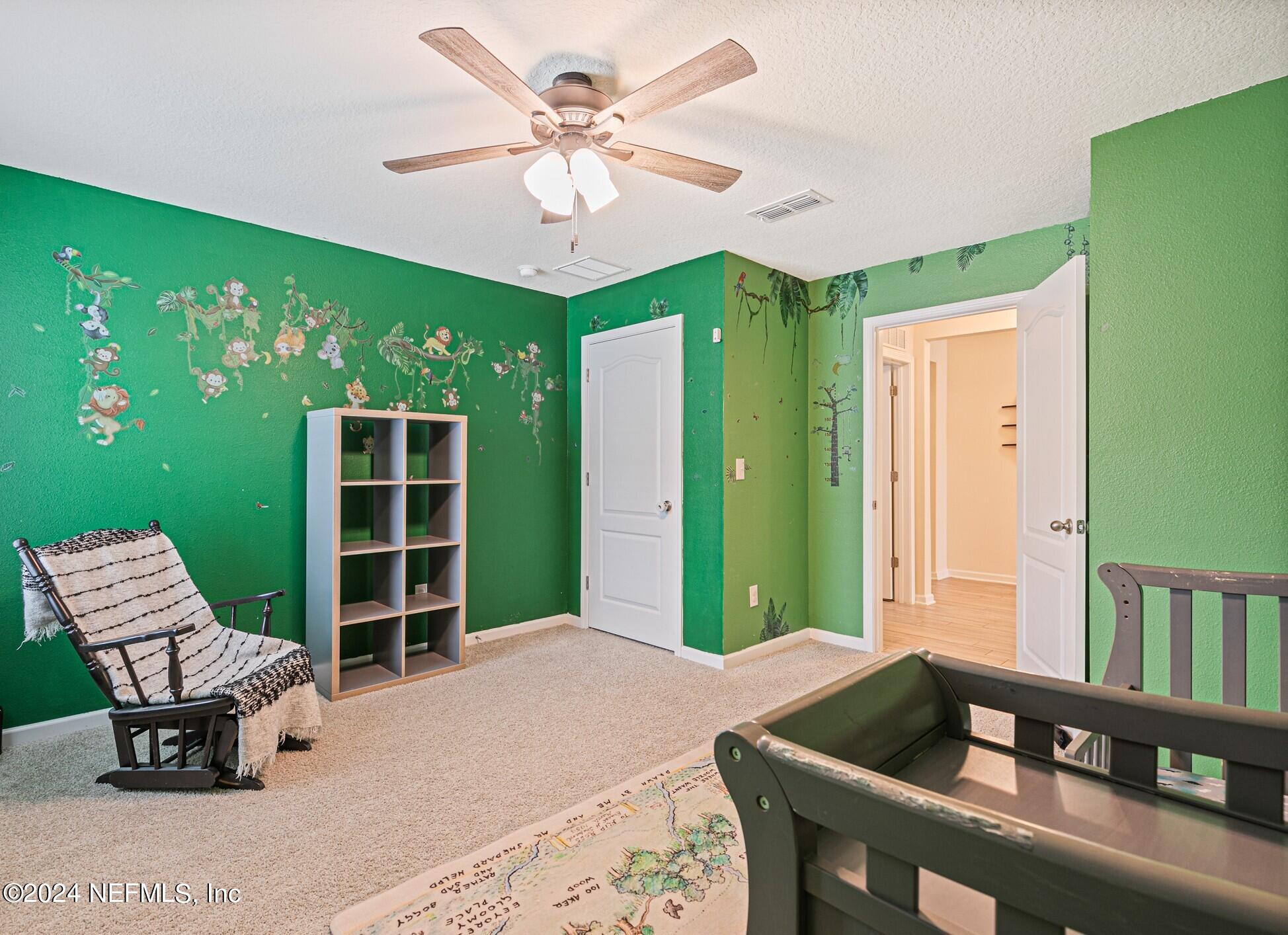 340 Chasewood Drive St. Augustine, FL 32095 - Photo 24 of 46 a bedroom with a large bed and a chandelier