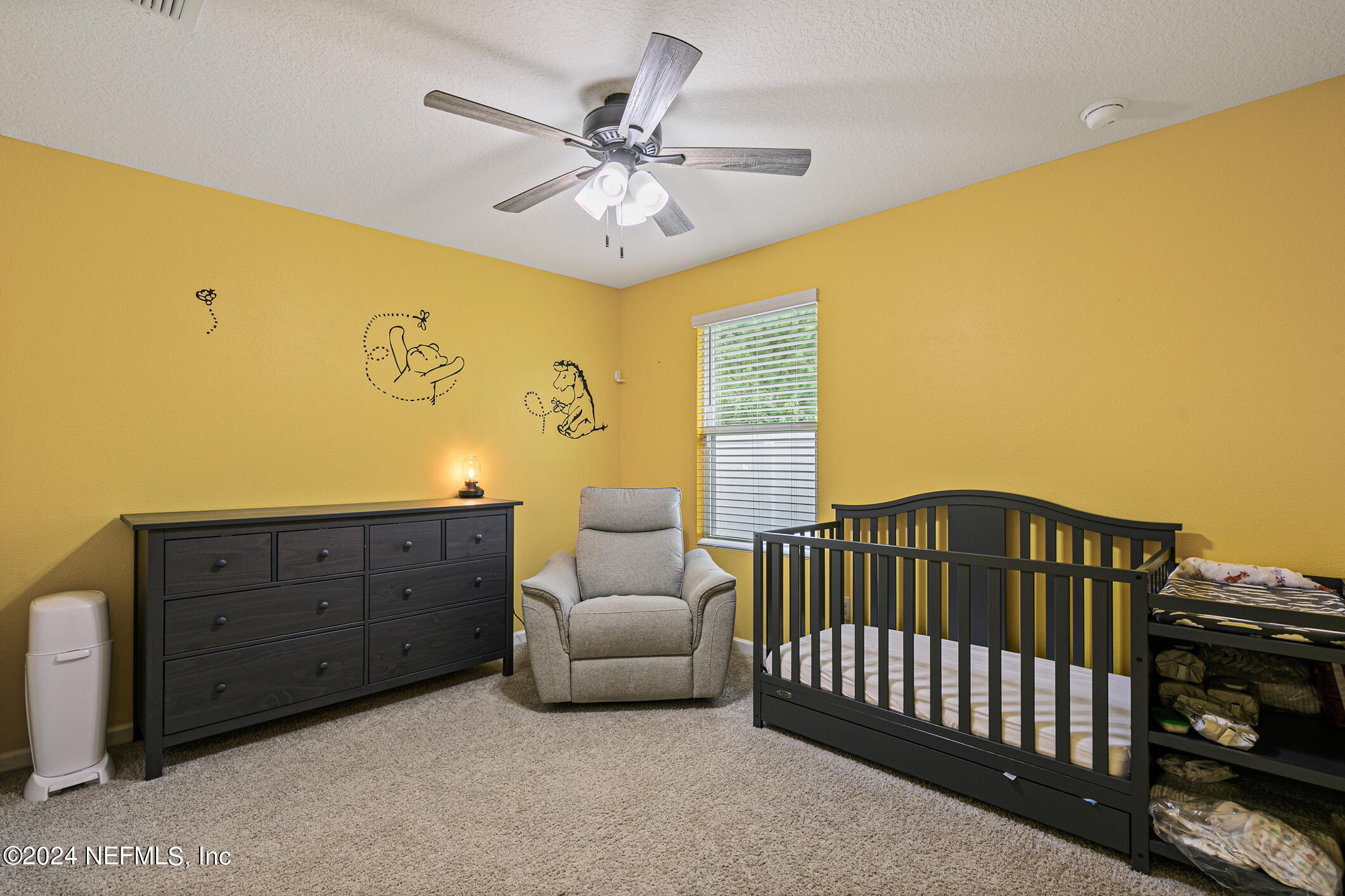 340 Chasewood Drive St. Augustine, FL 32095 - Photo 30 of 46 a bedroom with a bed and a chandelier