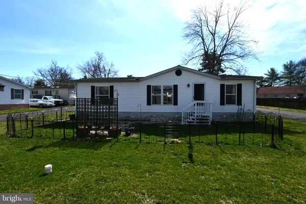 a front view of house with yard and outdoor seating