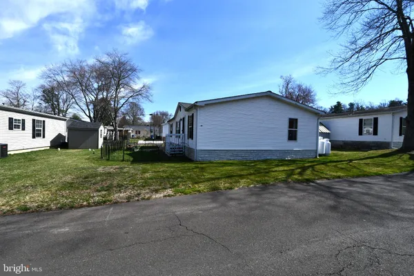 a view of house with backyard and garden