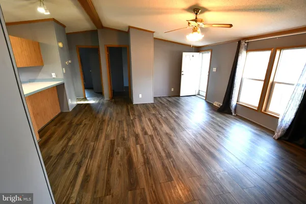 a view of a room with wooden floor and staircase