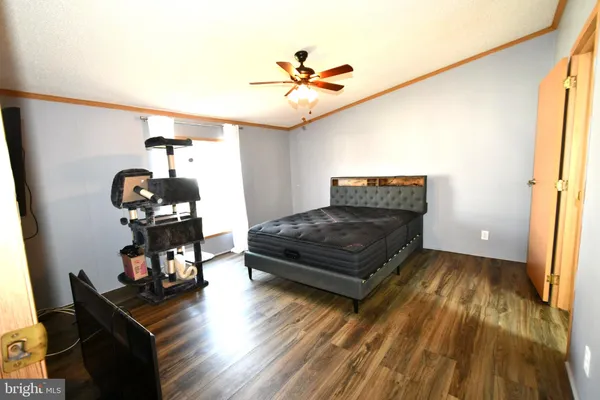 a living room with wooden floor furniture and a window